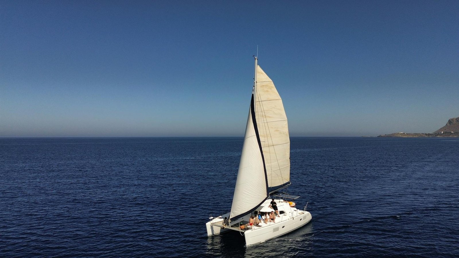 aerial view of sailing catamaran on open sea