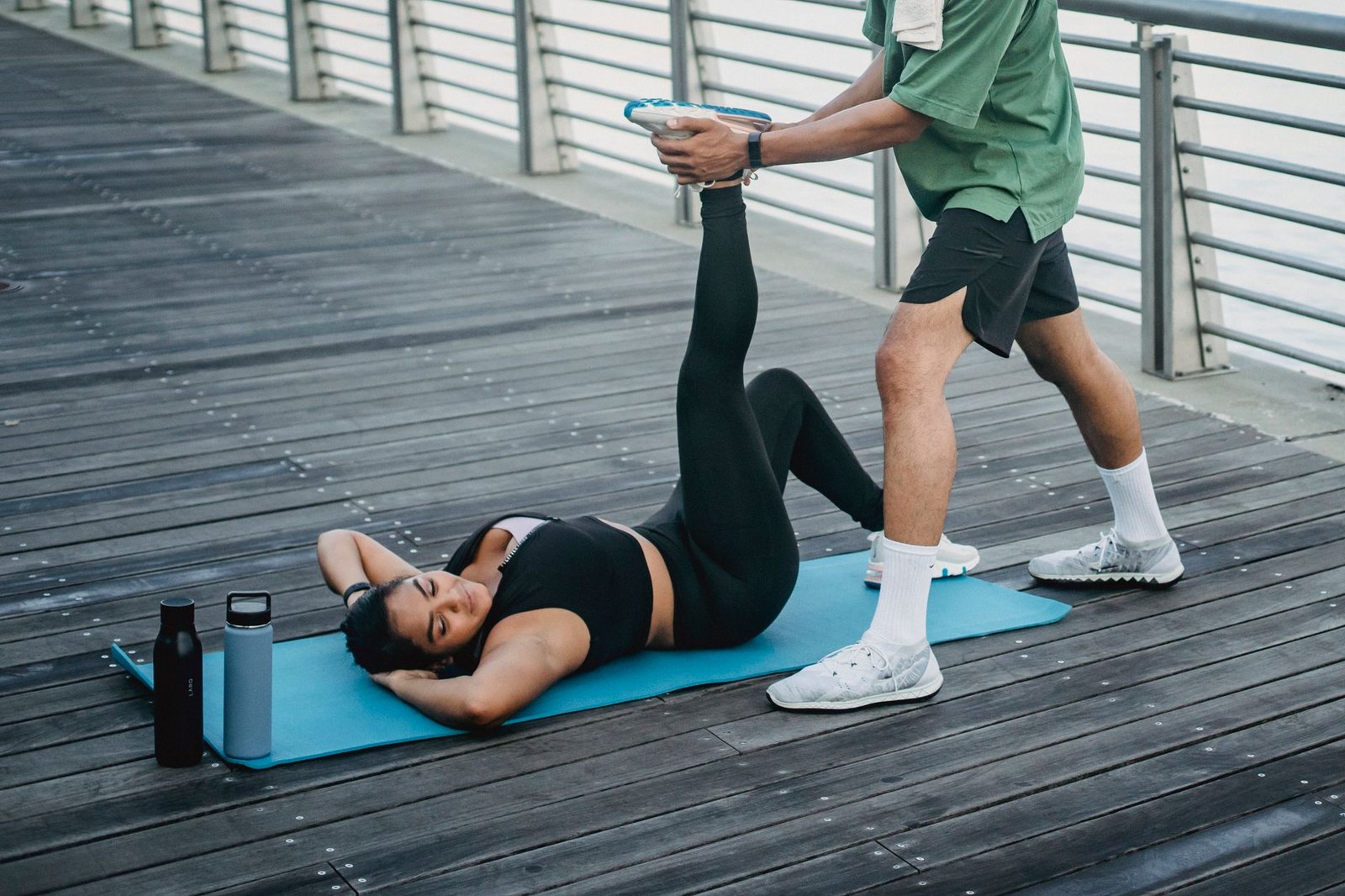 woman lying on yoga mat doing stretching